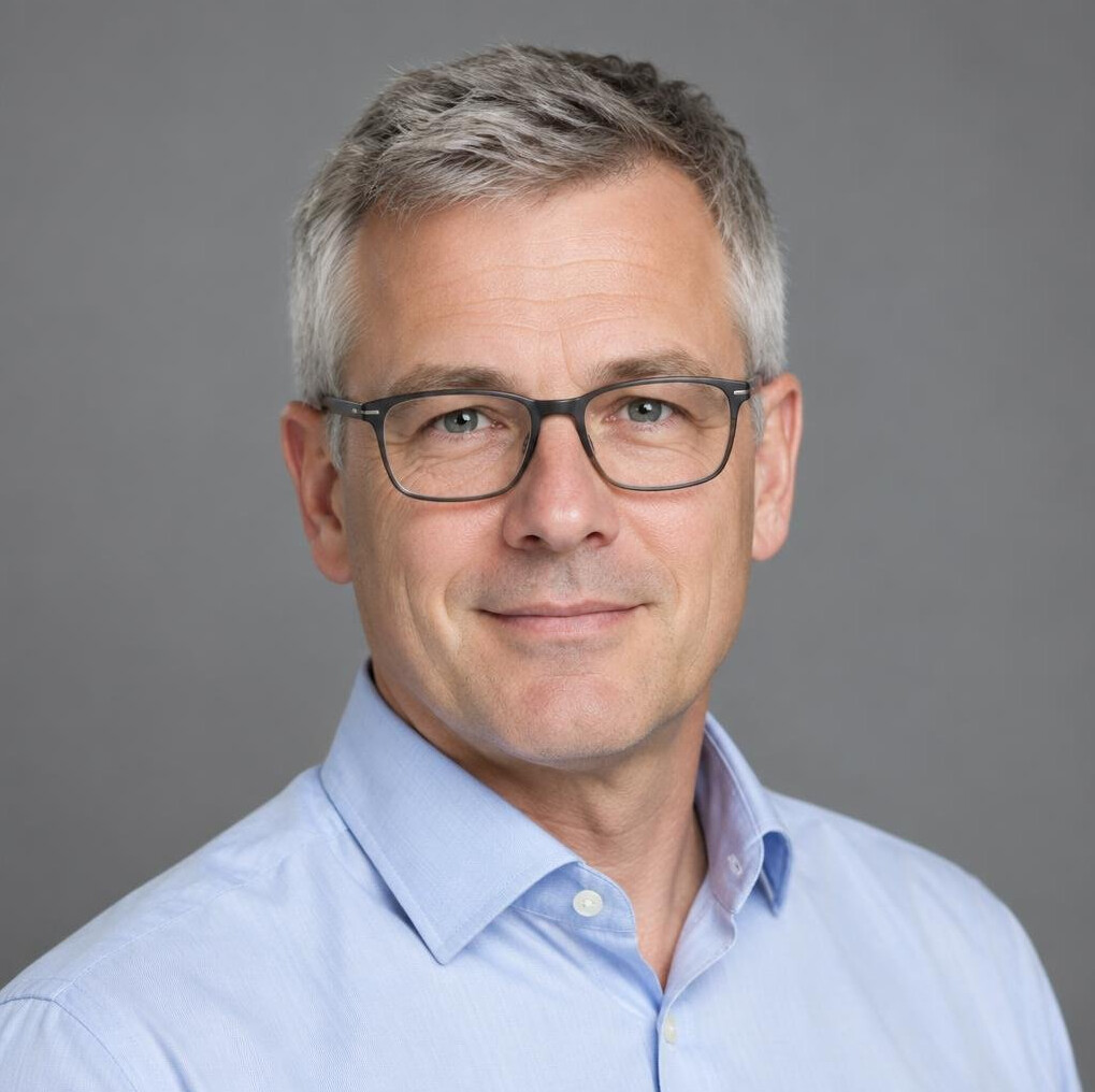 Studio portrait of a man broadcast producer with glasses